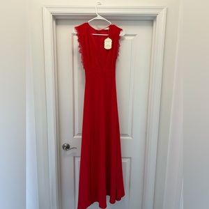 Floor length red dress with slit. Never worn. New with tags.